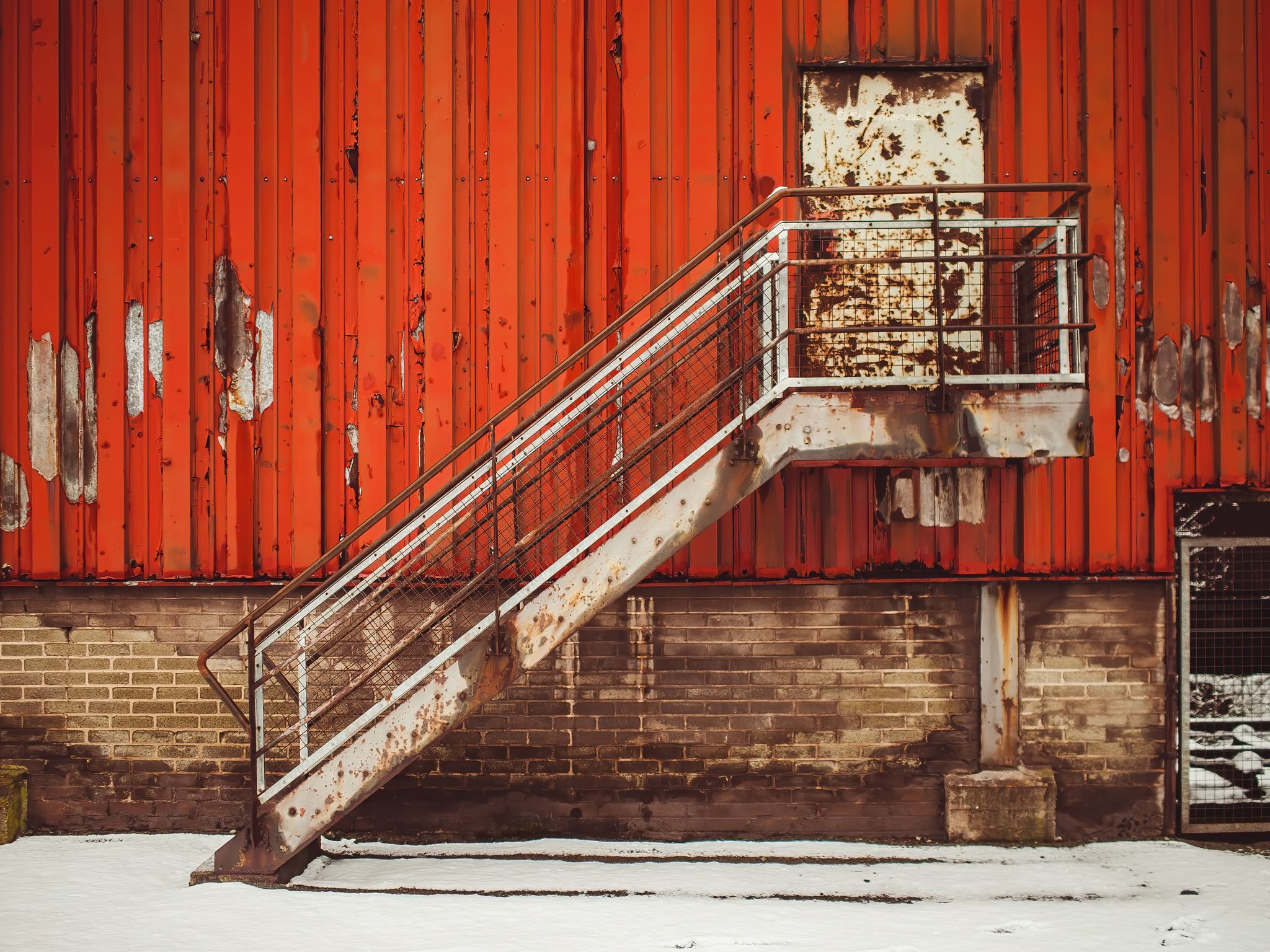 Exploring the industrial relics of the past in Saarland, Germany. This 19th century steel mill, now abandoned and rusty, tells the story of a bygone era in industrial history. Its antique brick buildings, metal equipment, and towering structures stand tall under the sunny skies, reminding us of the ingenuity and innovation of past generations. A UNESCO World Heritage Site, this factory is a famous place that still fascinates with its ancient architecture and impressive engineering. Take a step back in time and witness the past come to life in this industrial district.