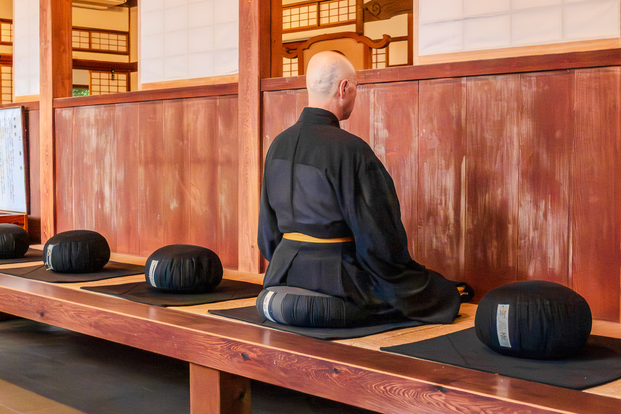 Finding peace in the heart of Japan: A monk meditates in deep contemplation during a Zen session.