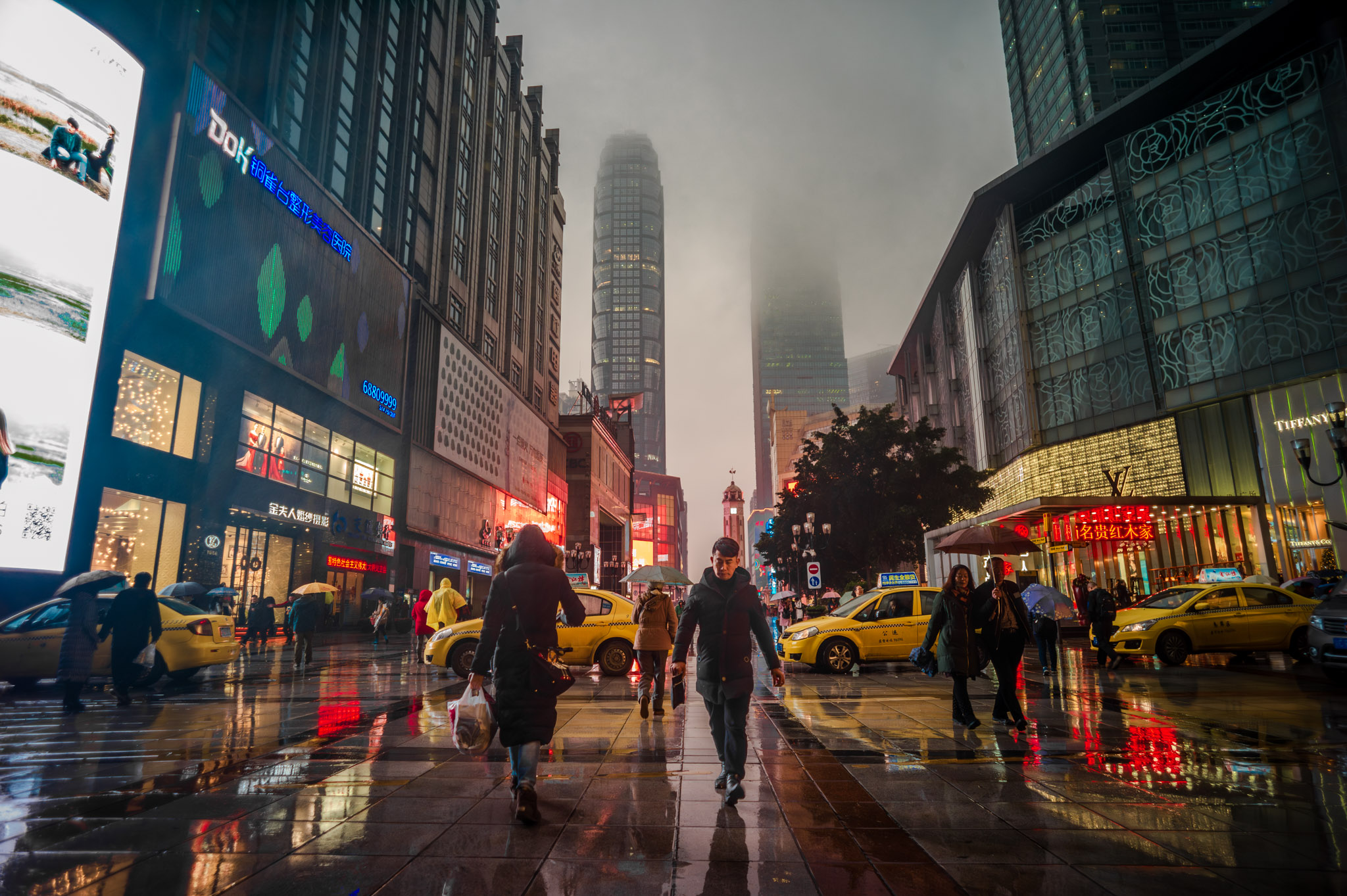 Sparkling city lights illuminate the modern skyscrapers and towering buildings of the bustling downtown business district, as the majestic bridge stands tall over the glistening river. This stunning night scene captures the vibrant energy and architectural marvels of the urban cityscape.