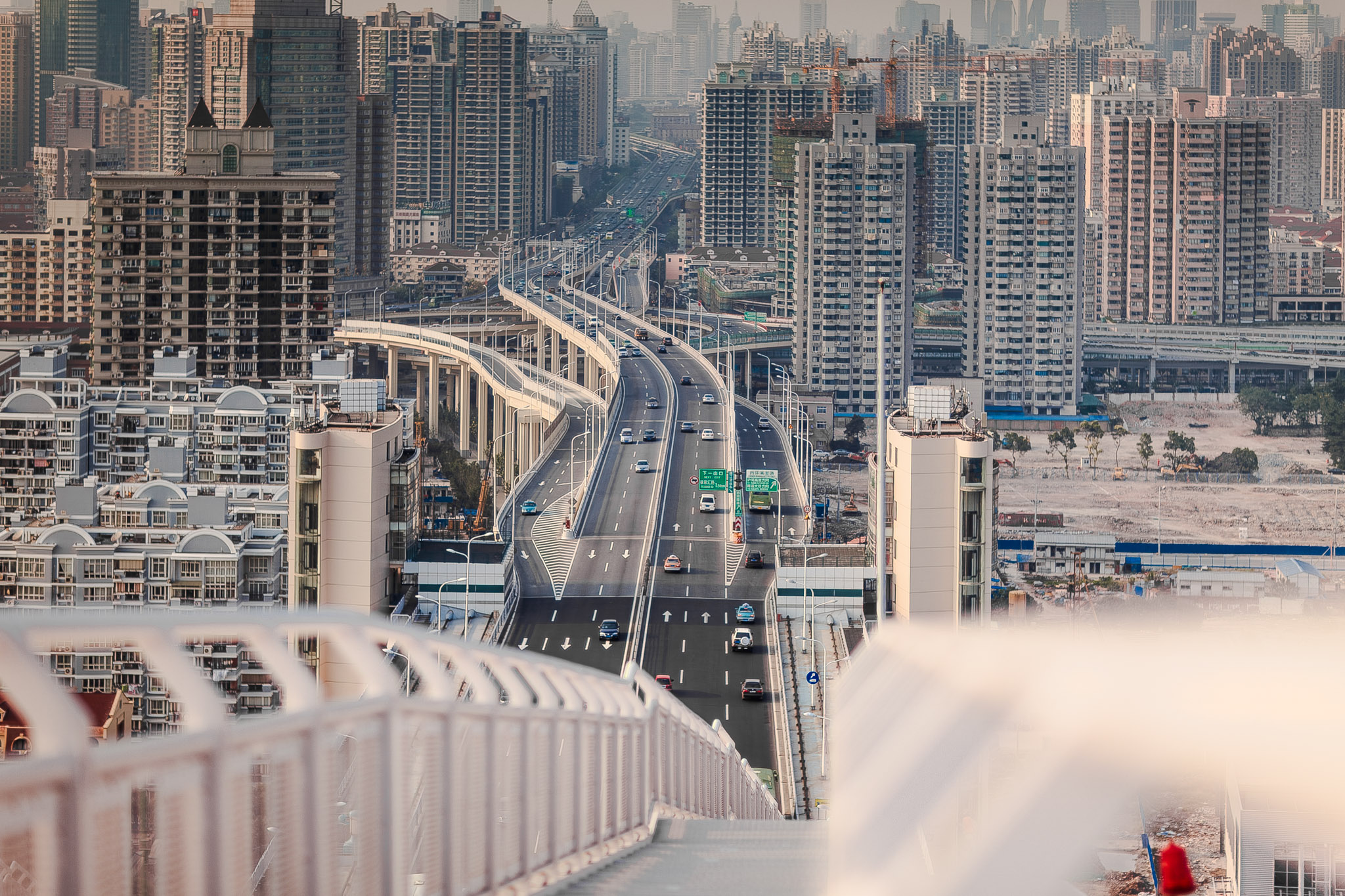 Gazing down upon the modern urban skyline, the city's towering skyscrapers and iconic landmarks create a stunning aerial scene. From the bustling business district to the bustling streets below, the architecture and towering structures of the city's center form a breathtaking cityscape at night, with the river running through it all. Join us on a journey through this bustling metropolis and discover the magic of its high-rise buildings, bustling office spaces, and majestic bridges that connect the downtown and business district.